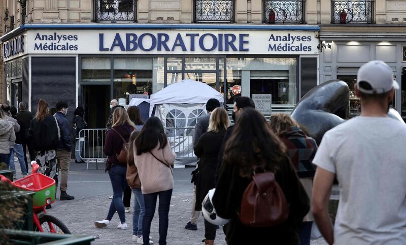 People queue to undergo a PCR test at a medical analysis laboratory in Paris. AFP