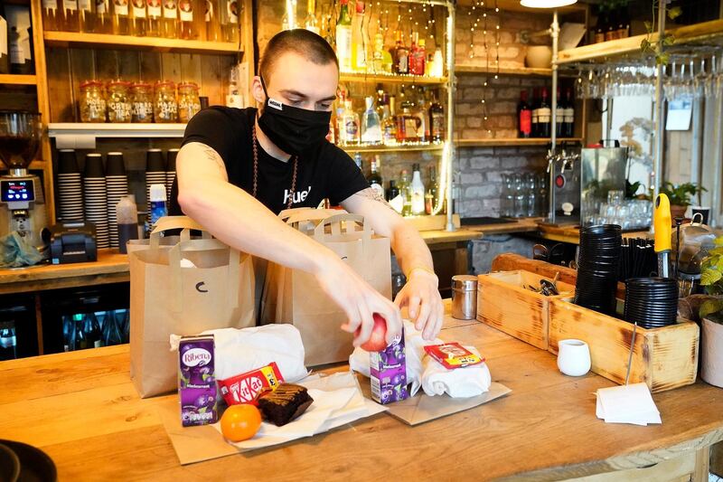 Staff at The Watering Can Restaurant and Cafe in Liverpool's Greenbank Park prepare free half-term meal packs for children. Getty Images