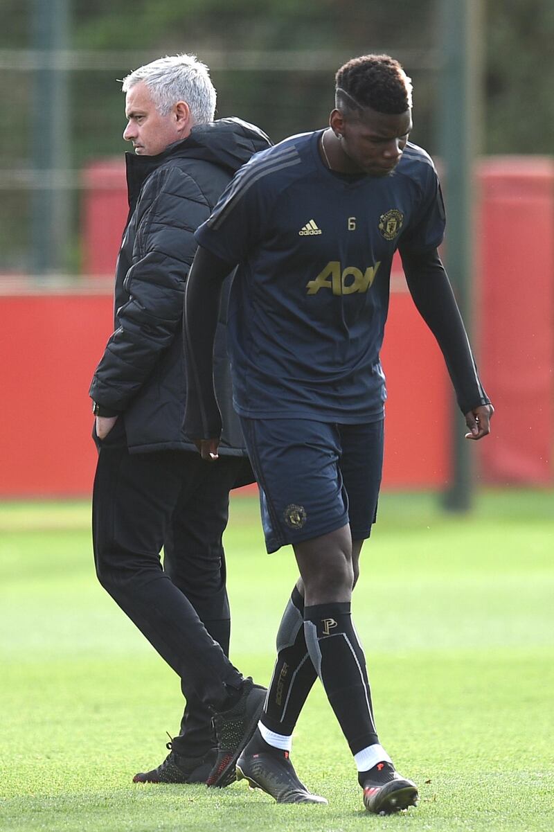 Manchester United's Portuguese manager Jose Mourinho (L) and Manchester United's French midfielder Paul Pogba (R) attend a training session at the Carrington Training complex in Manchester, north west England on October 22, 2018, ahead of their UEFA Champions League group H football match against Juventus on October 23. (Photo by Oli SCARFF / AFP)