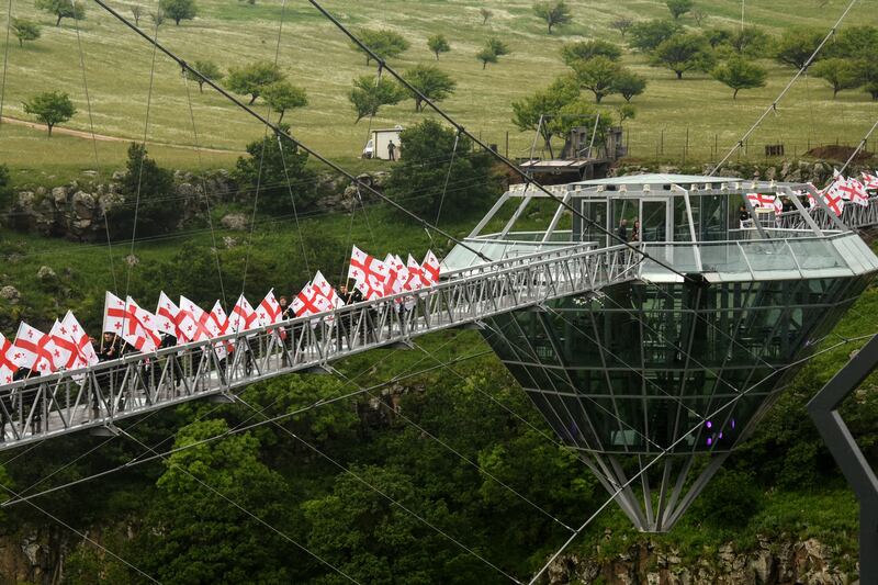 People attend the opening ceremony of a 240-metre-long glass bridge dubbed 'Diamond Bridge'. All photos: AFP