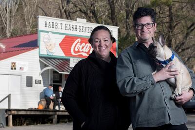 Wilbur, a 6-month-old French bulldog, poses for a portrait with owners Seth Westfall and Amy Noland in Rabbit Hash, Ky., on Nov. 13, 2020. Wilbur was elected the Mayor of Rabbit hash in November's election cycle. The town has elected a canine to the office of mayor since 1998. (Albert Cesare /The Cincinnati Enquirer via AP)