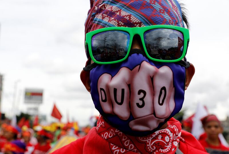 A masked anti-government protester takes part in a march towards the Philippine Congress ahead of president Rodrigo Duterte's State of the Nation address in Quezon city, Metro Manila. Erik De Castro / Reuters