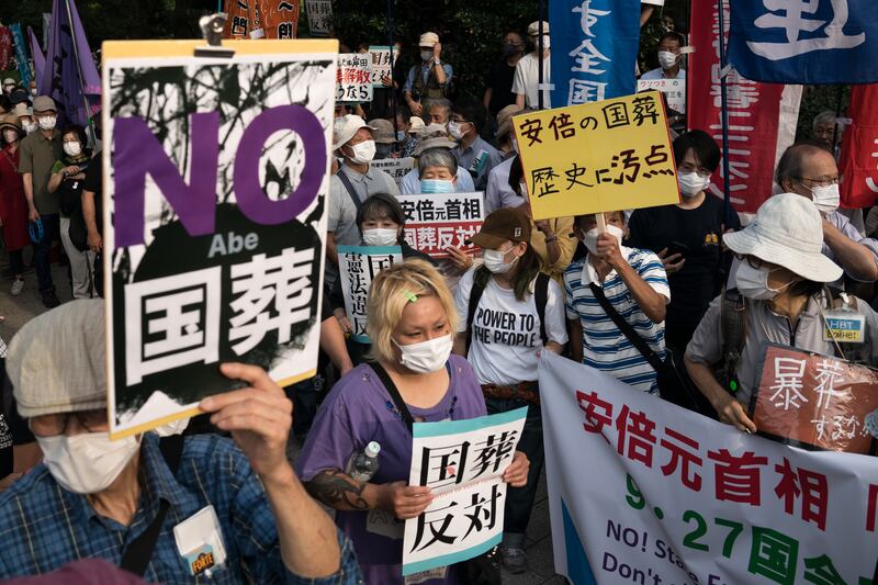 People gather outside the National Diet Building to protest against the funeral. Getty Images