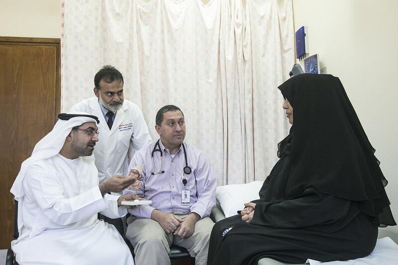 From left, Dr Ali Obaidli, chair of the National Transplant Committee, Dr Muhammad Zaman, head of transplantation services at Seha’s Sheikh Khalifa Medical City and Dr Nizar Attallah, consultant nephrologist, Cleveland Clinic Abu Dhabi with Fatima Al Blooshi. Mona Al Marzooqi / The National