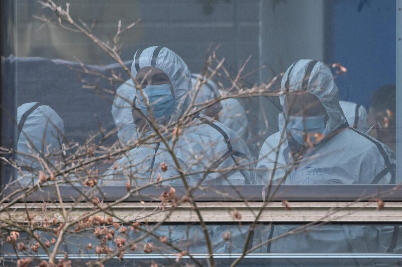 Members of the World Health Organisation (WHO) team investigating the origins of coronavirus wear protective gear during their visit to the Hubei Center for animal disease control and prevention in Wuhan, China's central Hubei province. AFP