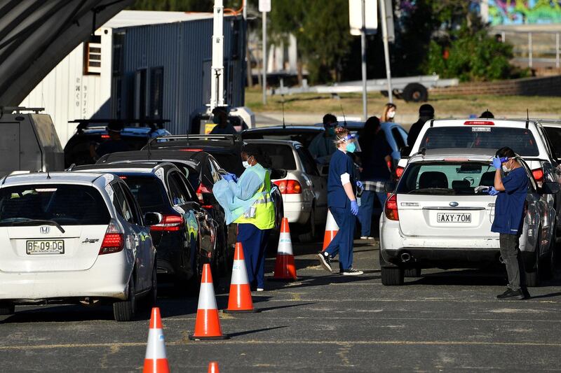 Health workers register people for coronavirus tests at a drive-through centre at Bondi beach in Sydney, New South Wales, as authorities lock down areas of Australia's largest city to contain an outbreak of the highly contagious Delta variant. AFP