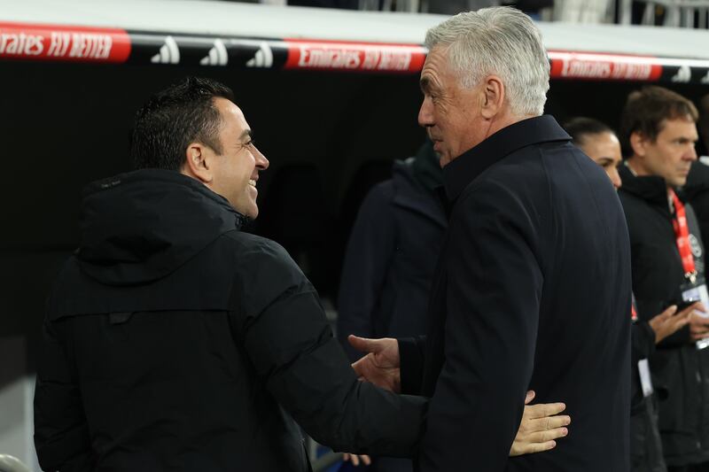 Barcelona coach Xavi, left, knows victory against Real Madrid rival Carlo Ancelotti in the clasico on Sunday will go a long way to sealing La Liga title. EPA