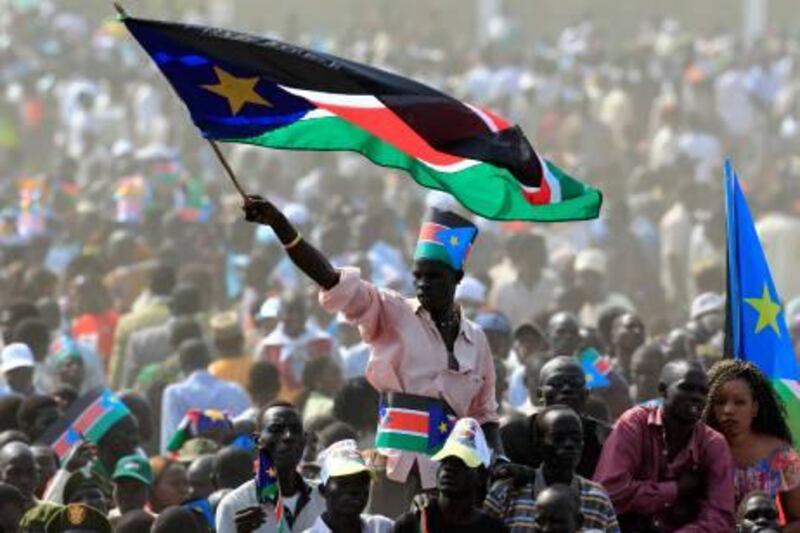 A man waves South Sudan's national flag as he attends the Independence Day celebrations in the capital Juba, July 9, 2011. Tens of thousands of South Sudanese danced and cheered as their new country formally declared its independence on Saturday, a hard-won separation from the north that also plunged the fractured region into a new period of uncertainty. REUTERS/Thomas Mukoya (SOUTH SUDAN - Tags: SOCIETY) *** Local Caption ***  AFR64_SOUTH-SUDAN-_0709_11.JPG
