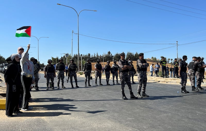 Police members block a road in an attempt to prevent protesters from reaching a border zone with the Israeli-occupied West Bank, in Amman, Jordan. Reuters