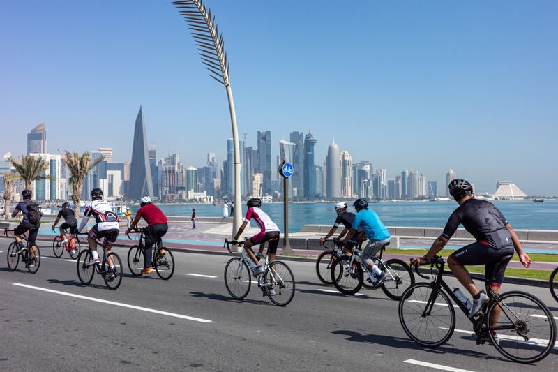 Cyclists ride along the Doha Corniche. Bloomberg