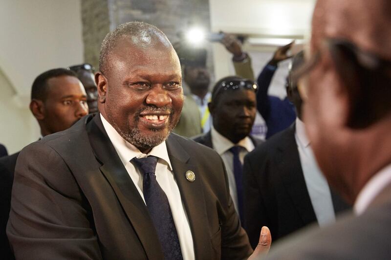 South Sudan's opposition leader Riek Machar, left,  arrives for the third round of Sudanese peace talks in Juba, South Sudan. AFP