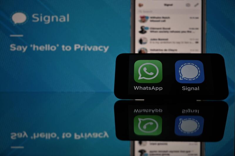 This photograph taken on 11 January, 2021 in Toulouse, southwestern France, shows the logos of WhatsApp and Signal mobile messaging services. Secure messaging app Signal is on the top downloads on Apple Store and Google Play platforms in several countries after the popular messaging app WhatsApp asked its some two billion users on January 7, 2021 to accept new terms that will allow it to share more information with its parents company Facebook and roll out advertising and e-commerce. / AFP / Lionel BONAVENTURE
