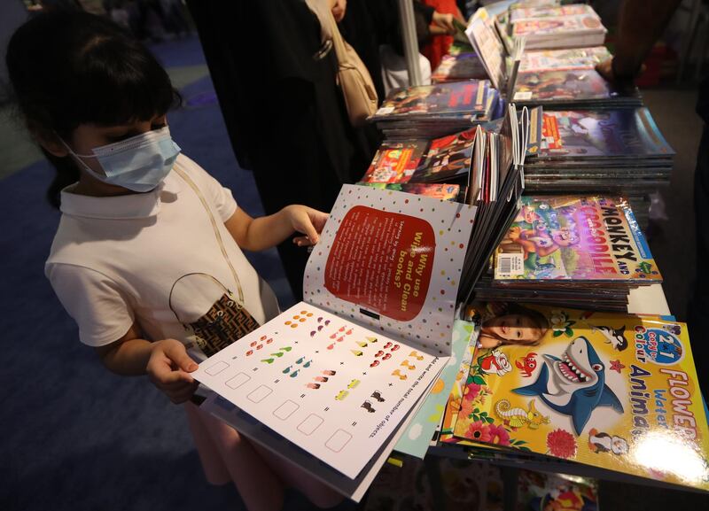 A schoolgirl inspects one of the many books on offer at the festival. EPA