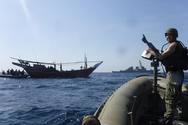 The Arleigh Burke-class guided-missile destroyer USS McFaul's visit, board, search and seizure team pulls alongside a Bahraini dhow during routine maritime security operations in the Arabian Gulf, June 25, 2019. Reuters