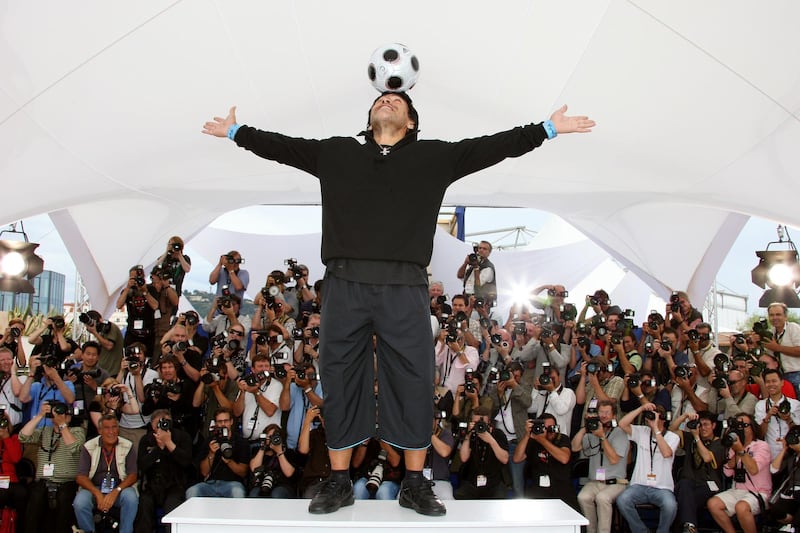 In this file picture taken on May 20, 2008 former Argentinian football player Diego Maradona controls the ball as he poses during a photocall for Serbian director Emir Kusturica's film 'Maradona by Kusturica' at the 61st Cannes International Film Festival in Cannes, southern France. Maradona turns 60 on October 30, 2020. AFP