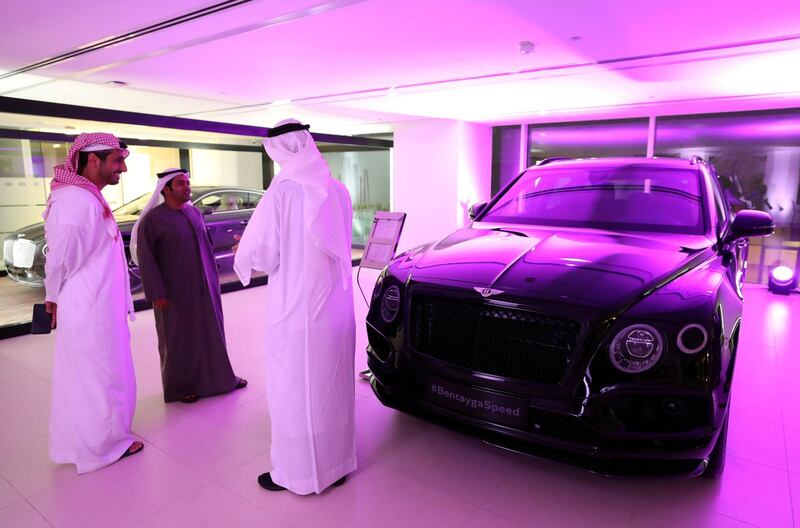 Abu Dhabi, United Arab Emirates - Reporter: Simon Wilgress-Pipe: Visitors next to a Bentley Bentayga Speed. The opening of the new Bentley Emirates showroom. Tuesday, January 21st, 2020. Abu Dhabi. Chris Whiteoak / The National