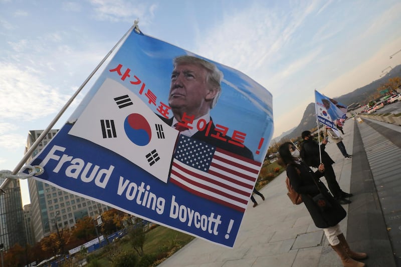 South Korean supporters of U.S. President Donald Trump hold flags near the U.S. Embassy in Seoul, South Korea. AP Photo