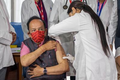 Indian Health Minister Harsh Vardhan is administered the COVAXIN vaccine, developed by Indian company Bharat Biotech, at a private hospital in New Delhi, India, Tuesday, March 2, 2021. India is expanding its coronavirus vaccination drive beyond health care and front-line workers, offering the shots to older people and those with medical conditions that put them at risk. (AP Photo/Altaf Qadri)