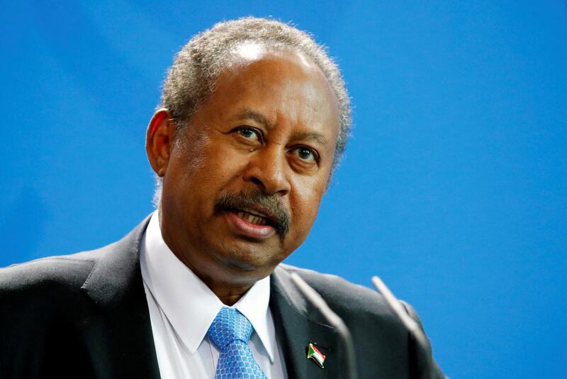 FILE PHOTO: Sudan's Prime Minister Abdalla Hamdok and German Chancellor Angela Merkel (not pictured) address the media at the Chancellery in Berlin, Germany, February 14, 2020. REUTERS/Hannibal Hanschke/File Photo