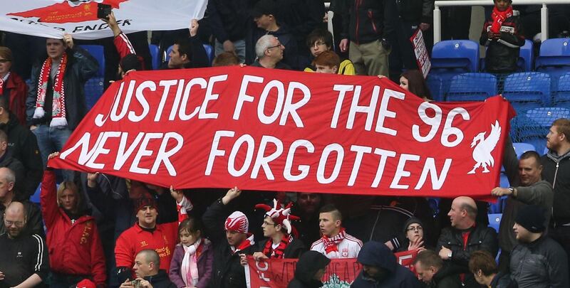 (FILES) In this file photo taken on April 13, 2013 Liverpool fans hold up banners commemorating those who lost their lives in the 1989 Hillsborough Disaster during the English Premier League football match between Reading and Liverpool at The Madejski Stadium in Reading, southern England. David Duckenfield, the police commander on duty at the 1989 Hillsborough stadium disaster, was found not guilty November 28, 2019 of the gross negligence manslaughter of 95 Liverpool fans who were crushed to death. / AFP / ANDREW COWIE
