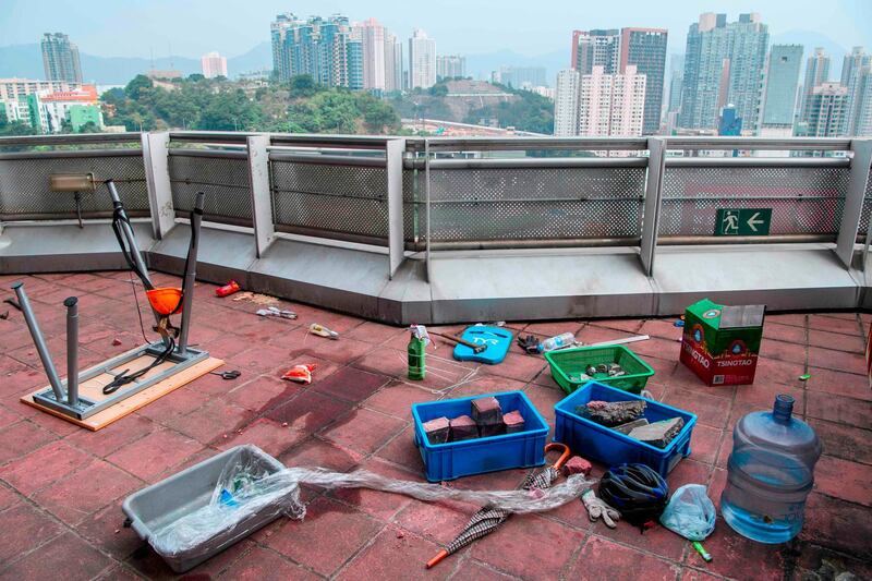 A molotov cocktail (C) with a battery attached to it is seen next to bricks and a makeshift catapult (L) on a rooftop at the Hong Kong Polytechnic University. AFP