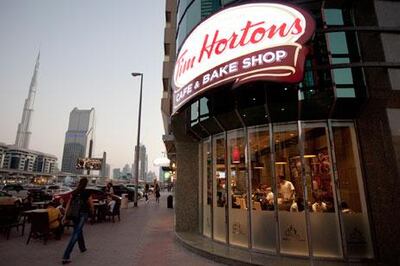 Customers wait in line at Tim Hortons coffee shop in Dubai, the first to open in the UAE.