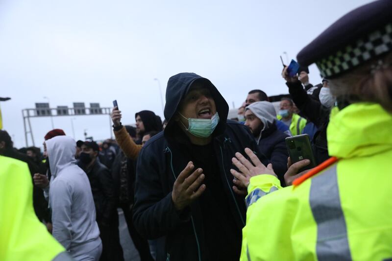 A man speaks to a police officer at the Port of Dover on December 23, 2020 in Dover, United Kingdom. Nearly 3,000 lorries were stranded around Kent after France banned all travel from the UK on Sunday, citing concerns over a new variant of covid-19. Late Tuesday, the countries reached a deal to restart freight travel for drivers with a recent negative covid-19 test. Getty Images