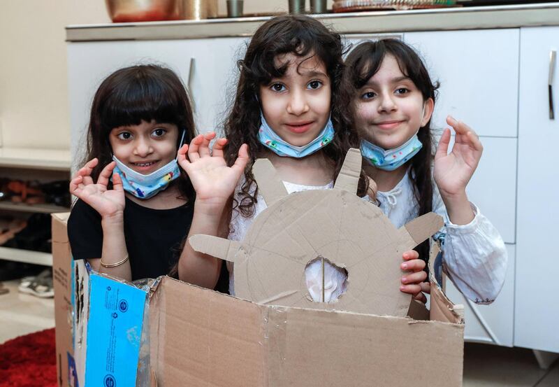 Abu Dhabi, United Arab Emirates, August 11, 2020.   ADNOC Family Education.  Alzaabi kids with their art projects::  (L-R) Meera-6, Hend-8, Noora-10 in their cardboard boat.
Victor Besa /The National
Section: NA
Reporter:  Mustafa Alrawi