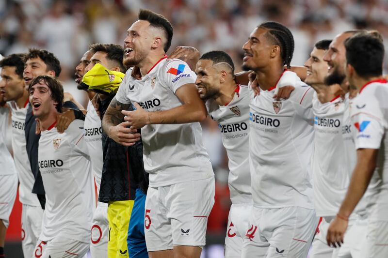 Sevilla players celebrate with supporters after their win over Manchester United. EPA