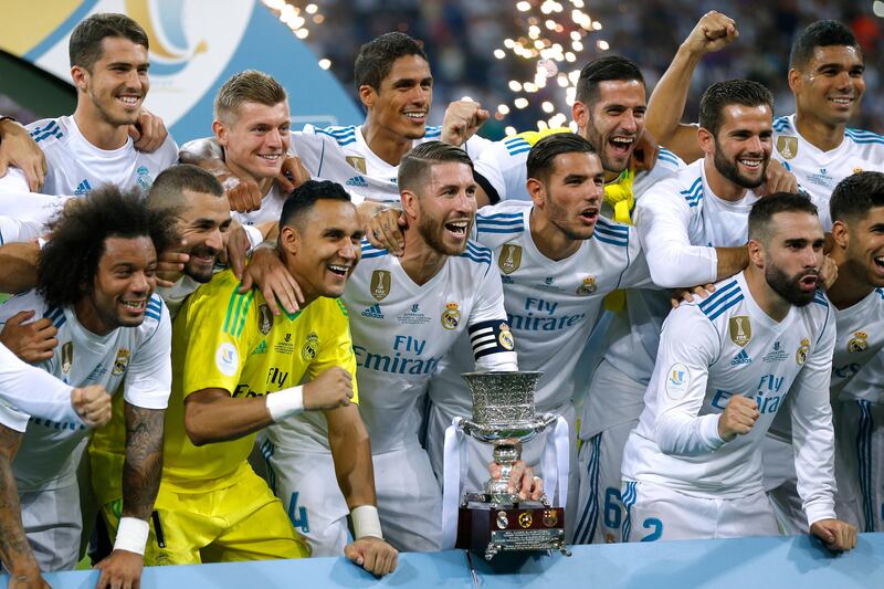 Real Madrid's players celebrate with their trophy after winning the Spanish Super Cup. Francisco Seco / AP Photo