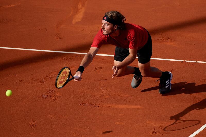 Stefanos Tsitsipas dives to return a ball against Rafael Nadal. Gettt