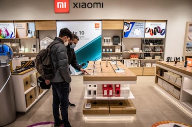 Customers browse Xiaomi smartphones at a retail store in Barcelona. The Chinese company produced more than 146 million smartphones last year, according to market intelligence firm TrendForce. Bloomberg
