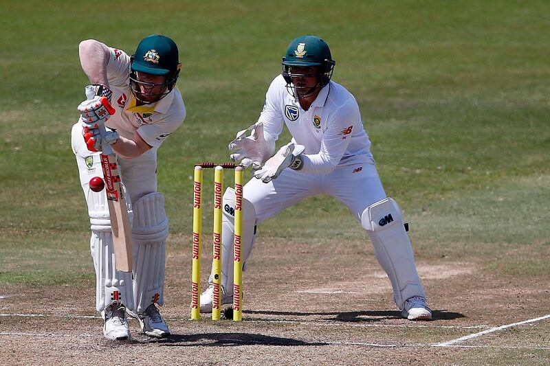 (FILES) In this file photograph taken on March 3, 2018, Australian batsman David Warner (L) is watched by South African wicketkeeper Quinton de Kock as he plays a shot on the third day of the first Test cricket match between South Africa and Australia at The Kingsmead Stadium in Durban.
Australian coach Darren Lehmann expects the coaches and captains of both teams to "chat" before the second Test against South Africa starting in Port Elizabeth on March 9, 2018, after a bad-tempered start to the series. Lehmann was talking to Australian journalists after an acrimonious ending to the first Test in Durban after leaked closed-circuit television footage showed a confrontation between Australian vice-captain David Warner and South Africa's Quinton de Kock.
 / AFP PHOTO / MARCO LONGARI