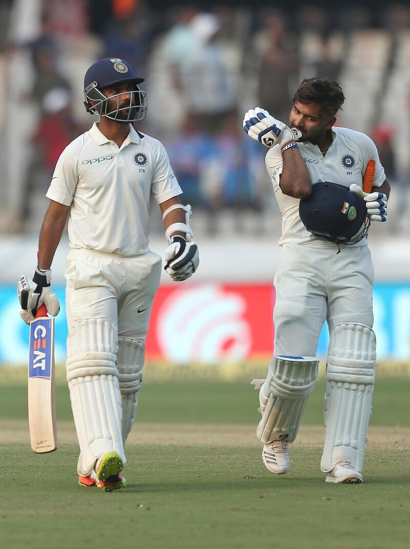 Indian cricketer Ajinkya Rahane, left, Rishabh Pant walk back to the pavillion at the end of the second day of the second cricket test match between India and West Indies in Hyderabad, India, Saturday, Oct. 13, 2018. (AP Photo/Mahesh Kumar A.)