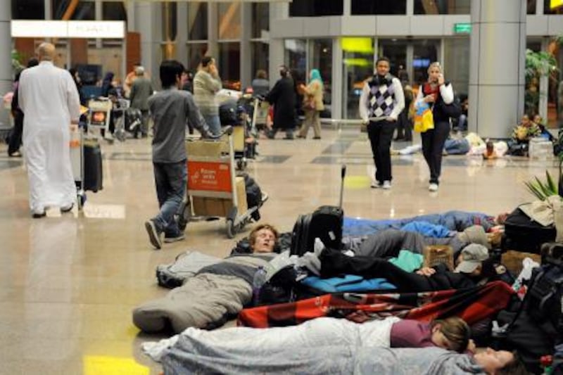 Tourists and Egyptians stranded at Cairo’s international airport sleep late on January 29, 2011 as they can’t leave the airport due to the curfew being brought forward in the Egyptian capital following anti-government riots. AFP PHOTO/MIGUEL MEDINA
 *** Local Caption ***  171941-01-08.jpg