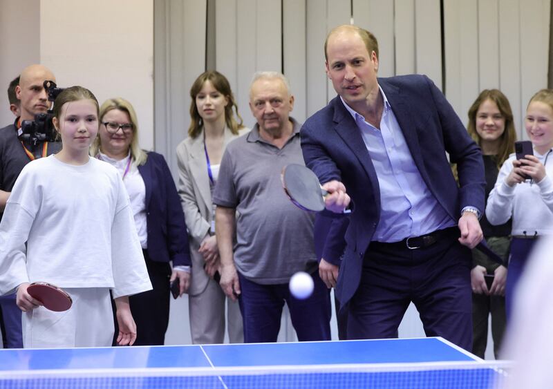 Prince William plays table tennis at the accommodation centre. Reuters