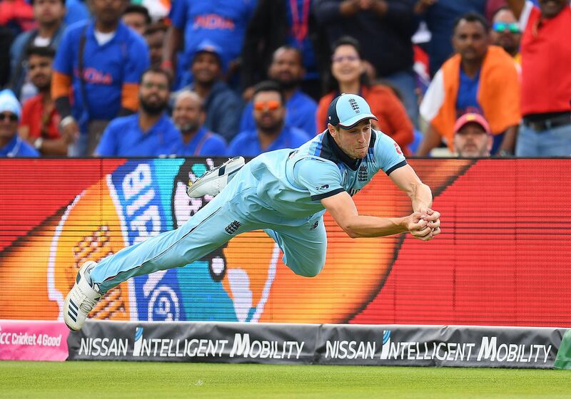 BIRMINGHAM, ENGLAND - JUNE 30:  Chris Woakes dives to take a catch to dismiss Rishabh Pant of India during the Group Stage match of the ICC Cricket World Cup 2019 between England and India at Edgbaston on June 30, 2019 in Birmingham, England. (Photo by Clive Mason/Getty Images)