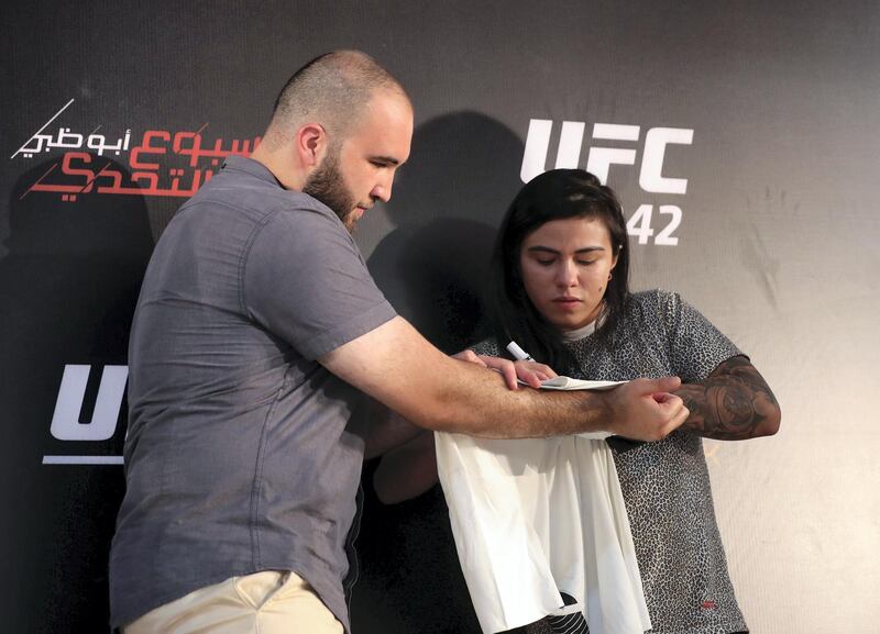 Abu Dhabi, United Arab Emirates - September 06, 2019: Claudia Gadelha signs an autograph at the UFC fan zone. Friday the 6th of September 2019. Yes Island, Abu Dhabi. Chris Whiteoak / The National