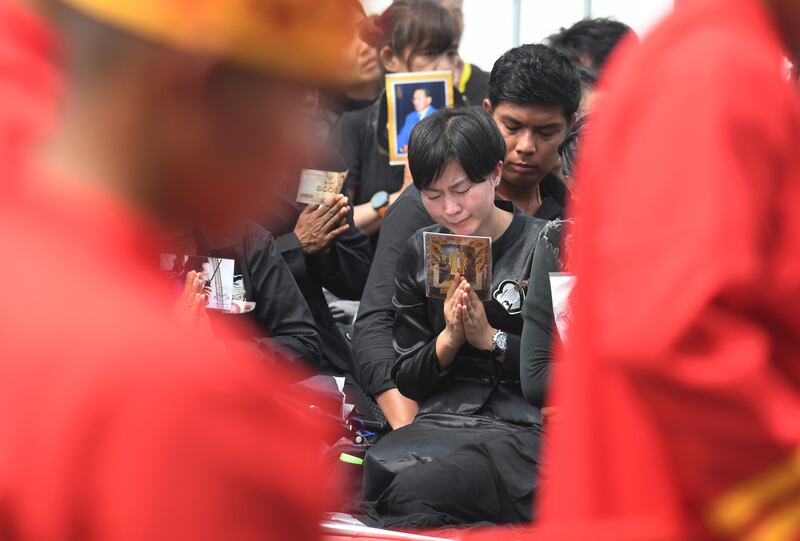 Mourners pray during the funeral procession and royal cremation ceremony of late Thai King Bhumibol Adulyadej, in Bangkok, Thailand. Kittinun Rodsupan / AP Photo.