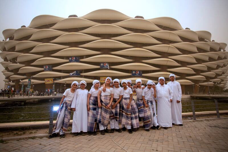 Youths pose for a picture in front of Basra International Stadium in Iraq's southern city of Basra. All photos: AFP