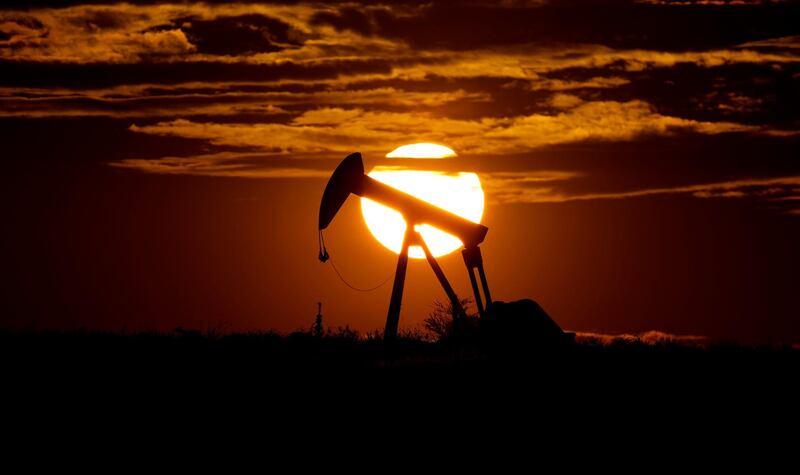 FILE - In this Wednesday, April 8, 2020, file photo, the sun sets behind an idle pump jack near Karnes City, USA. Oil prices pressed higher Monday, March 8, 2021,  after strikes on major oil facilities in Saudi Arabia, the worldâ€™s largest oil exporter, shook energy markets. (AP Photo/Eric Gay, File)