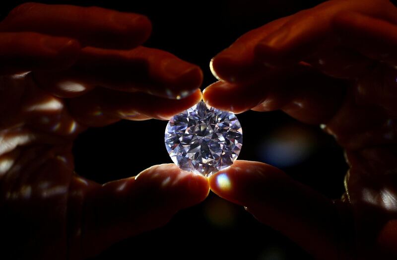 An assistant holds a 102.34 carat white diamond at Sotheby's auction house in London, Britain February 8, 2018. REUTERS/Hannah McKay     TPX IMAGES OF THE DAY