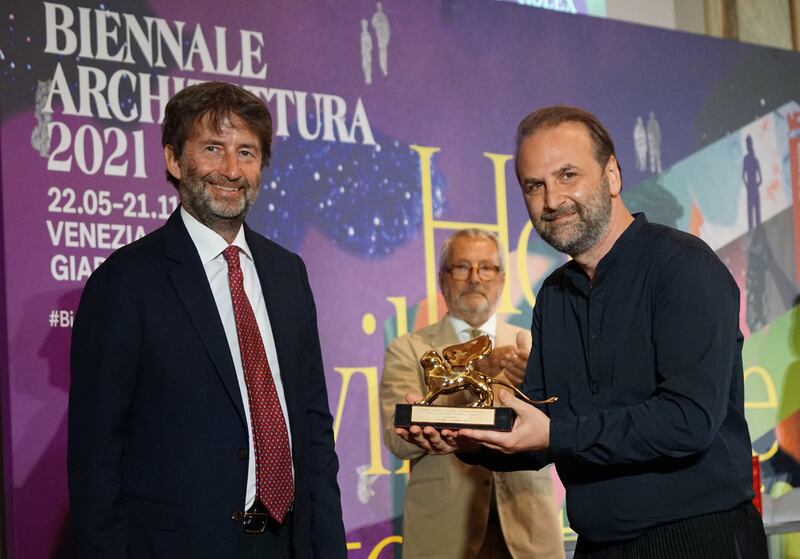 Roberto Cicutto, president of the Venice Biennale, applauds as Italy's culture minister Dario Franceschini, left, awards the Golden Lion for the Best National Participation to Wael Al Awar, right, curator of the Wetland project. EPA