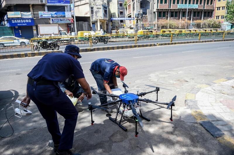 Ahmedabad Fire and Emergency Services personnel fill a drone with disinfectant to be sprayed on streets during a government-imposed nationwide lockdown as a preventive measure against the COVID-19 coronavirus, in Ahmedabad on May 9, 2020. / AFP / SAM PANTHAKY
