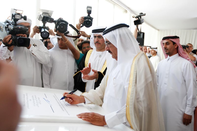 Dubai, April 8, 2013 - (L to R) Saeed Mohammed Al Tayer managing director and CEO of DEWA, watches as Sheikh Hamdan bin Rashid Al Maktoum,
Deputy Ruler of Dubai, Minister of Finance, and President of DEWA, signs an inauguration document at the opening ceremony of ÒM-StationÓ, the largest power production and water desalination plant in the UAE, in Dubai, April 8, 2013. (Photo by: Sarah Dea/The National)


