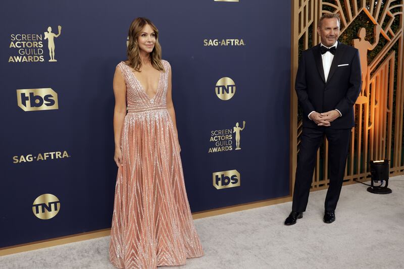 Christine Baumgartner and Kevin Costner at the 28th Screen Actors Guild Awards. Christine is wearing a dress by Tony Ward. AFP