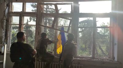 Ukrainian soldiers raising their flag after re-taking the village of Blahodatne in Donetsk. Reuters