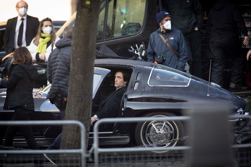 Robert Pattinson is seen getting into a car on set. Getty Images