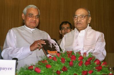Indian Prime Minister Atal Bihari Vajpayee, left, holds a book written by former Prime Minister P. V. Narasimha Rao, right, during a book release ceremony in New Delhi Wednesday April 8, 1998. Neither fiction nor autobiography, the novel opens a window on the grimy world of Indian politics, populated largely by ruthless self-seekers, sycophants and outright crooks. (AP Photo/Ajit Kumar)