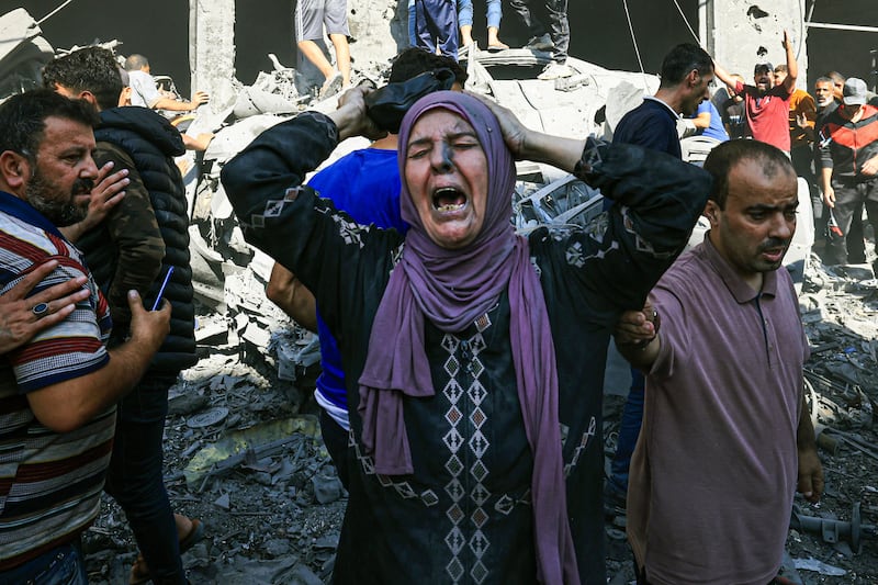 A Palestinian woman looks for victims in the rubble of a building following an Israeli strike in Khan Younis. AFP